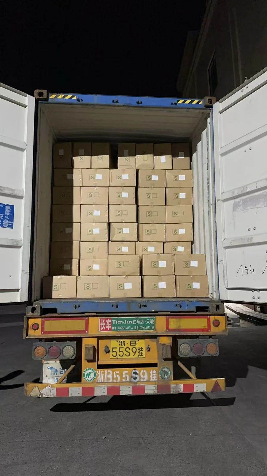 An open freight container loaded with packed goods during field operations.